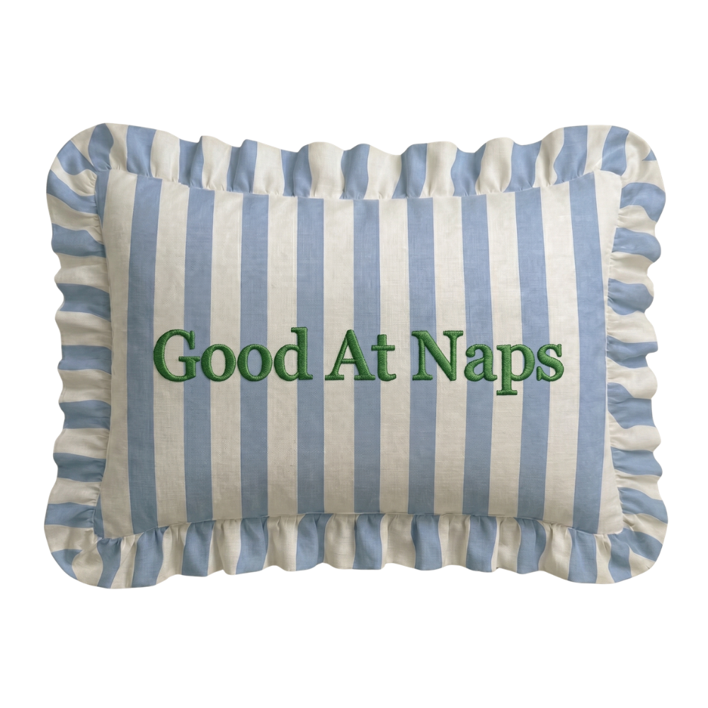 Striped pillow with 'Good At Naps' text on a white background