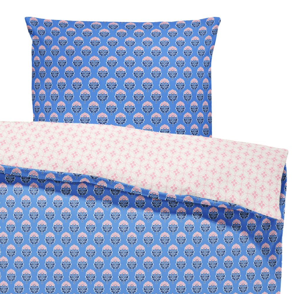 Bedding set with blue and pink patterned duvet cover and pillowcase on a white background