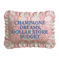 Decorative pillow with floral pattern and text 'Champagne Dreams, Dollar Store Budget' on a white background