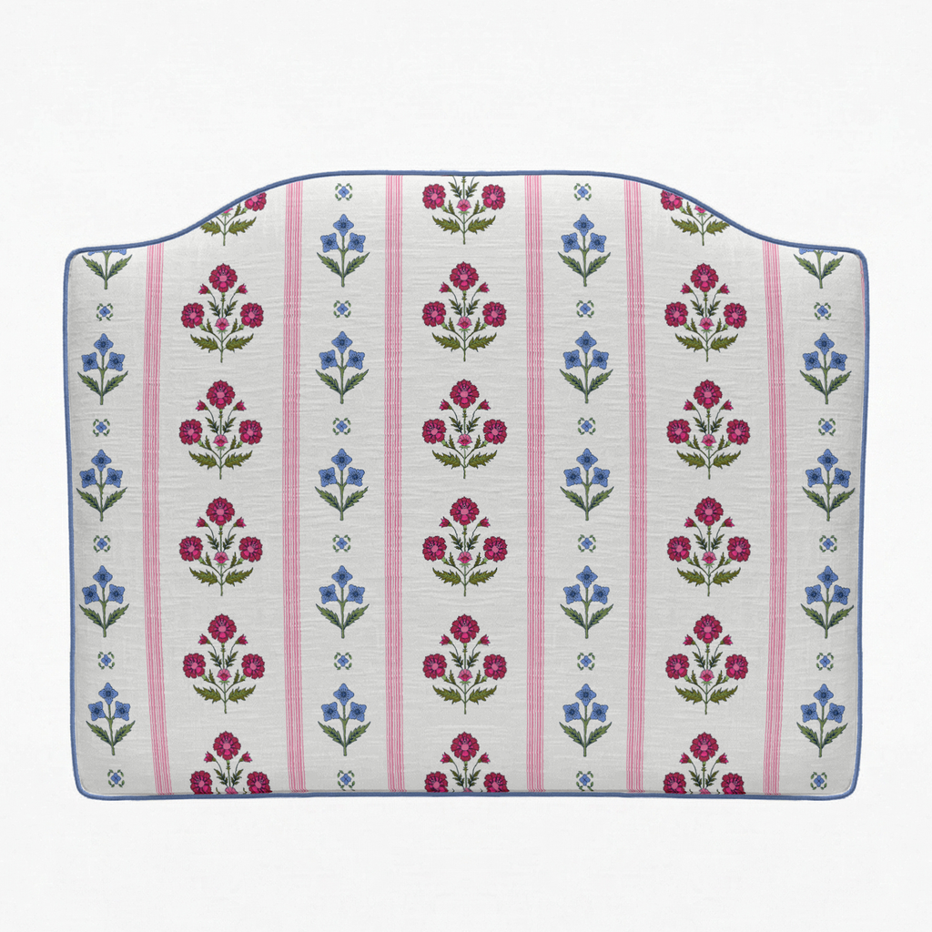 Floral patterned cushion with pink stripes on a white background