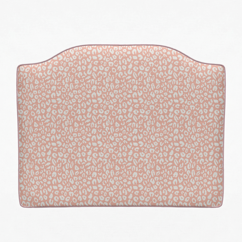 Pink headboard with subtle pattern on a white background